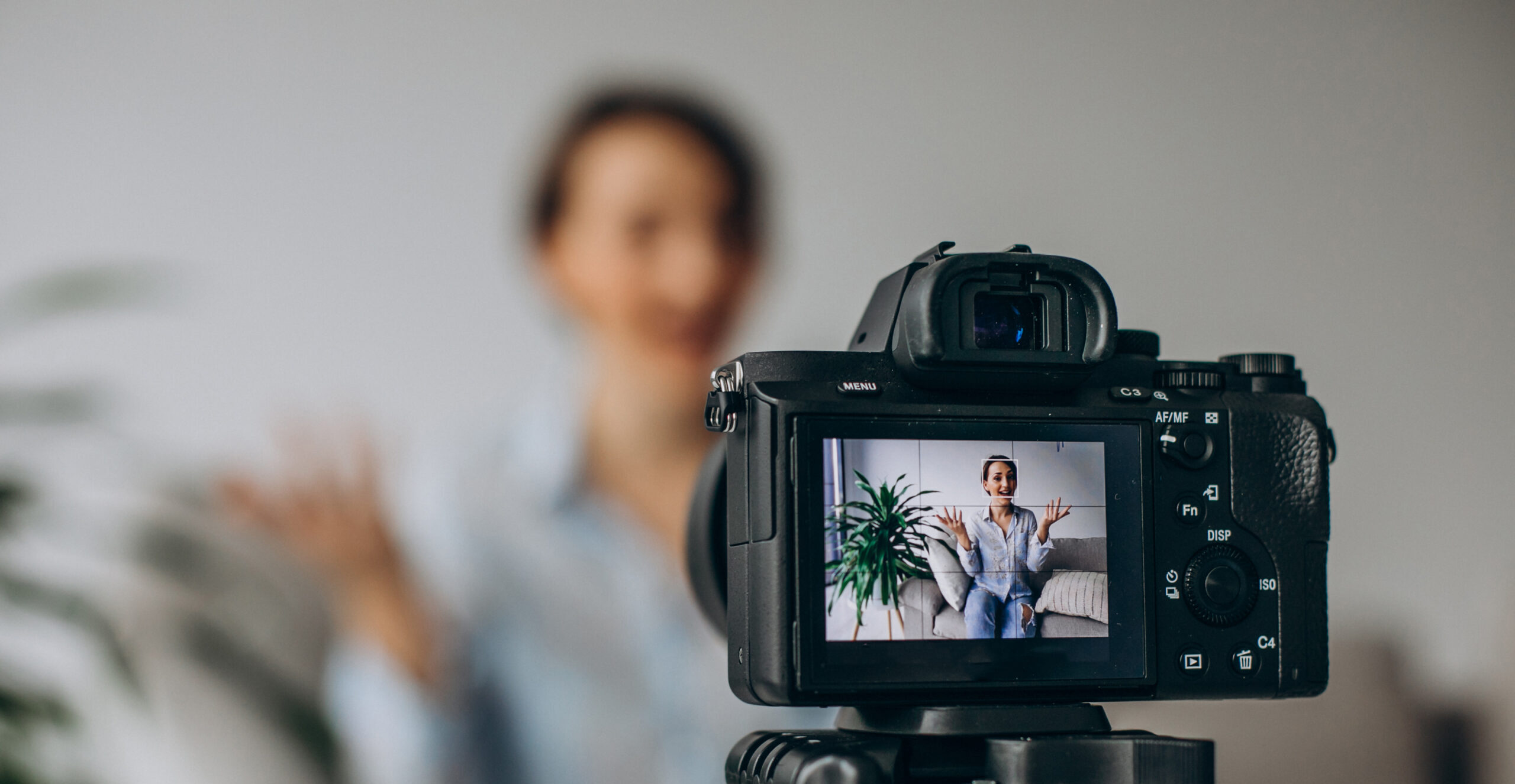 Young woman blogger recording video on camera